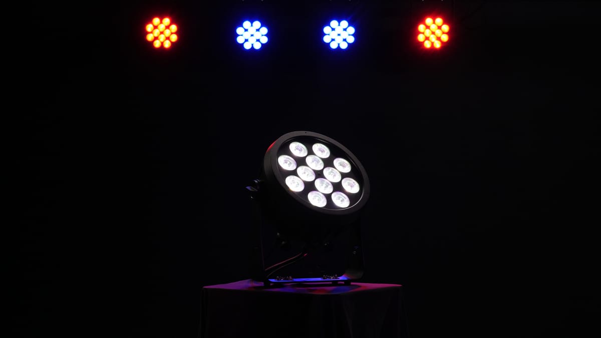 Rodie X12 producing white light on stage beneath a row of amber and blue wash fixtures